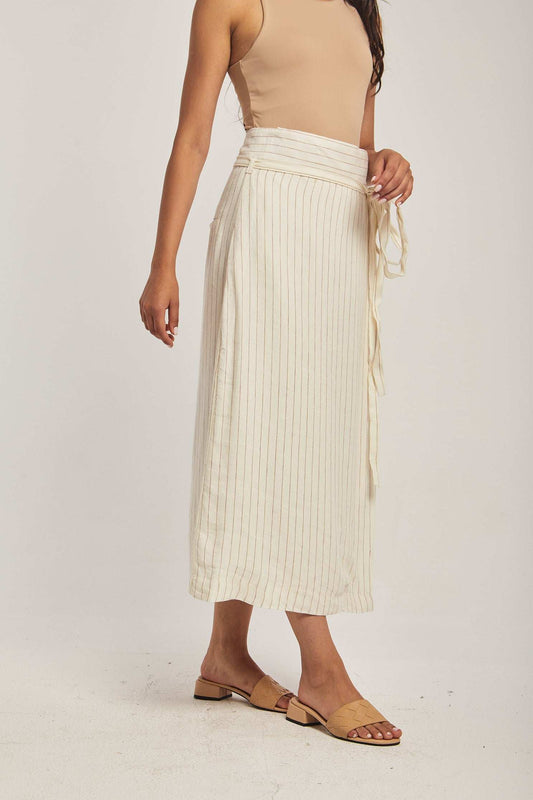 Woman wearing beige sleeveless top and cream striped midi skirt by Dalydress
