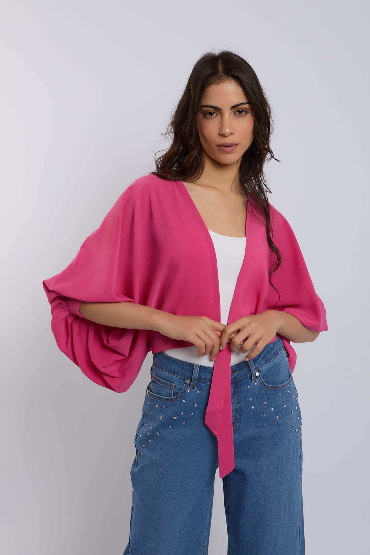 Woman in Dalydress pink kimono top and blue studded jeans, casual women's fashion
