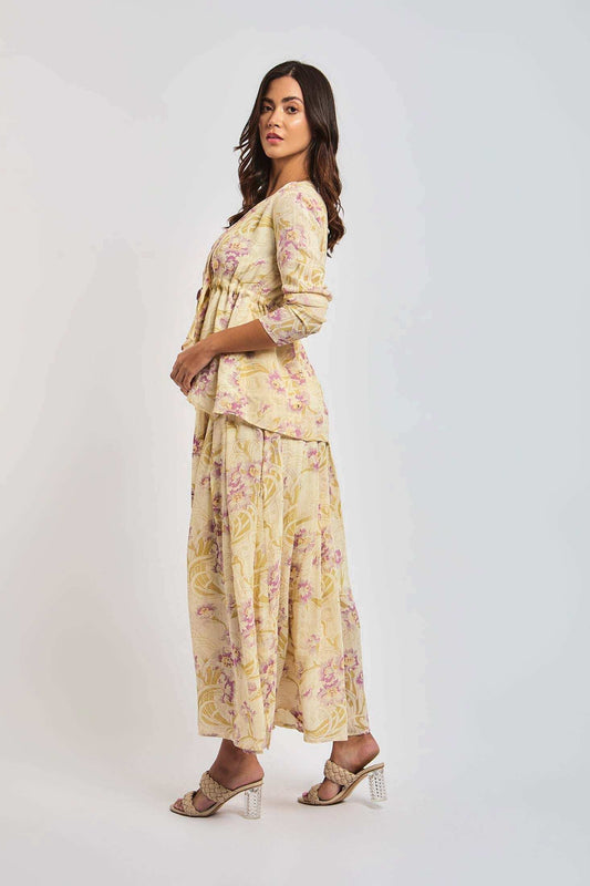 Woman in Dalydress yellow floral print set with flowy maxi skirt and three-quarter sleeve top