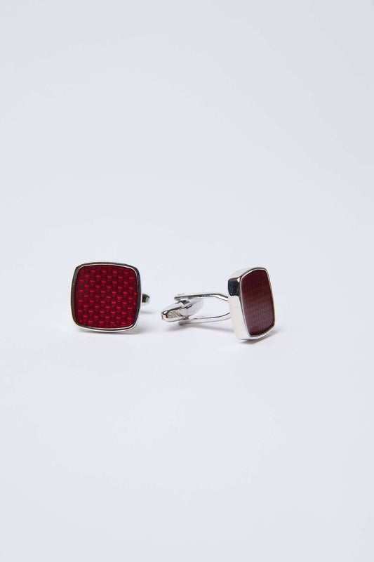 Square silver cufflinks with textured red inlay on white background