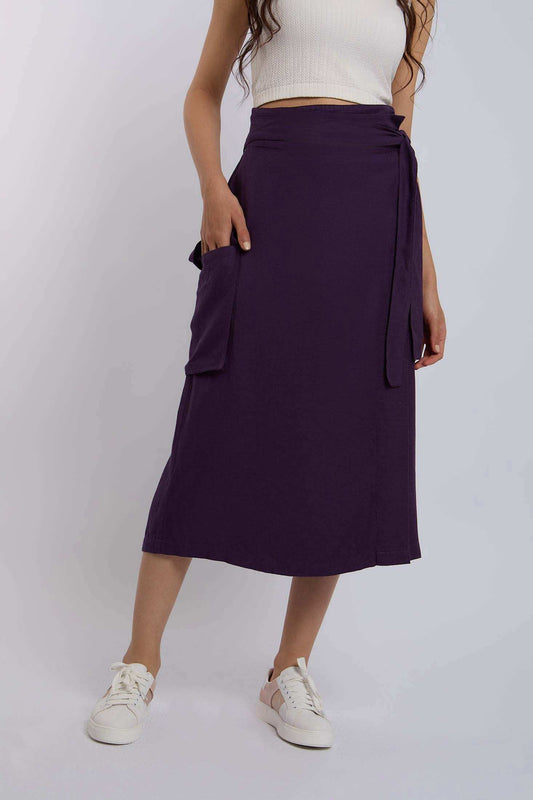 Woman wearing a purple wrap midi skirt with pocket and white crop top