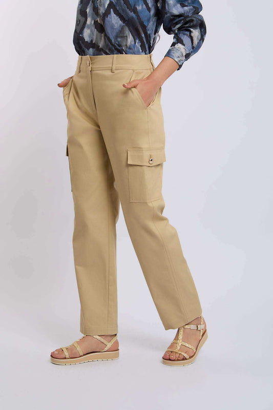 Woman wearing beige cargo pants with side pockets and strappy sandals