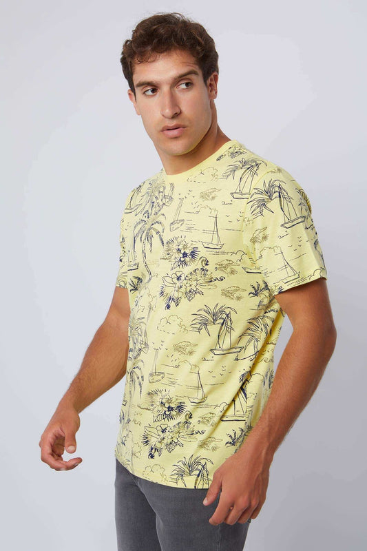 Man wearing a Dalydress yellow tropical print t-shirt and grey pants, casual menswear