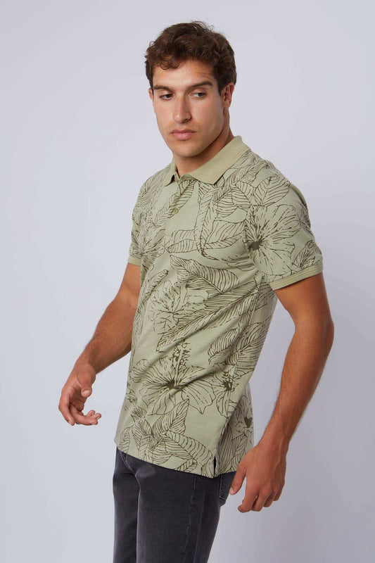 Man wearing short-sleeve light green floral print polo shirt and dark pants
