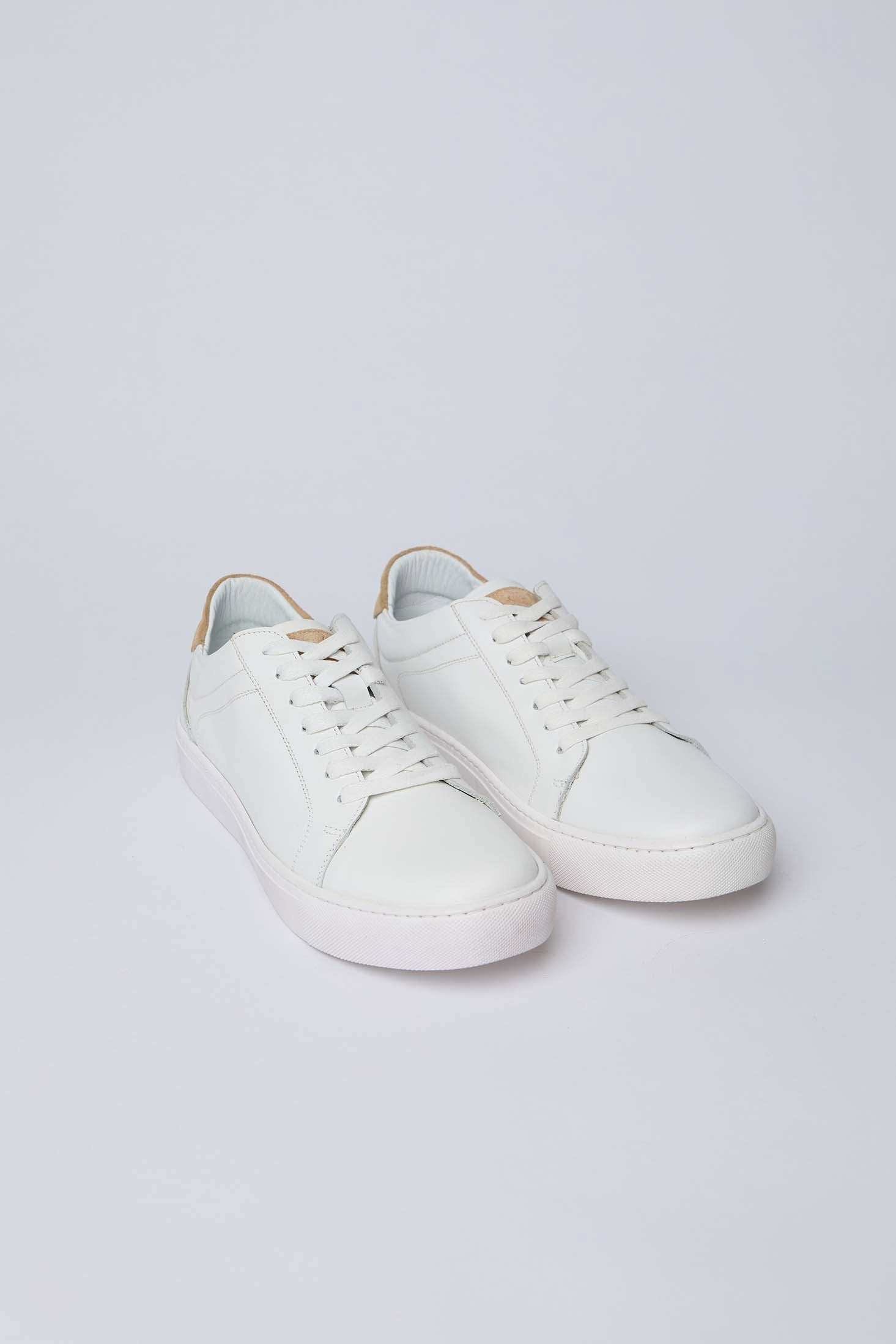 Dalydress white leather sneakers with tan heel accent on a light background
